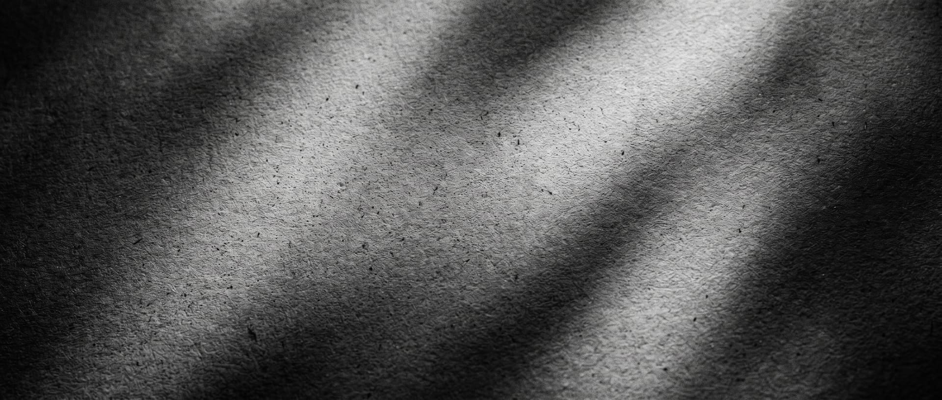 Texture abstraite en noir et blanc, tissu drapé sous une lumière directionnelle